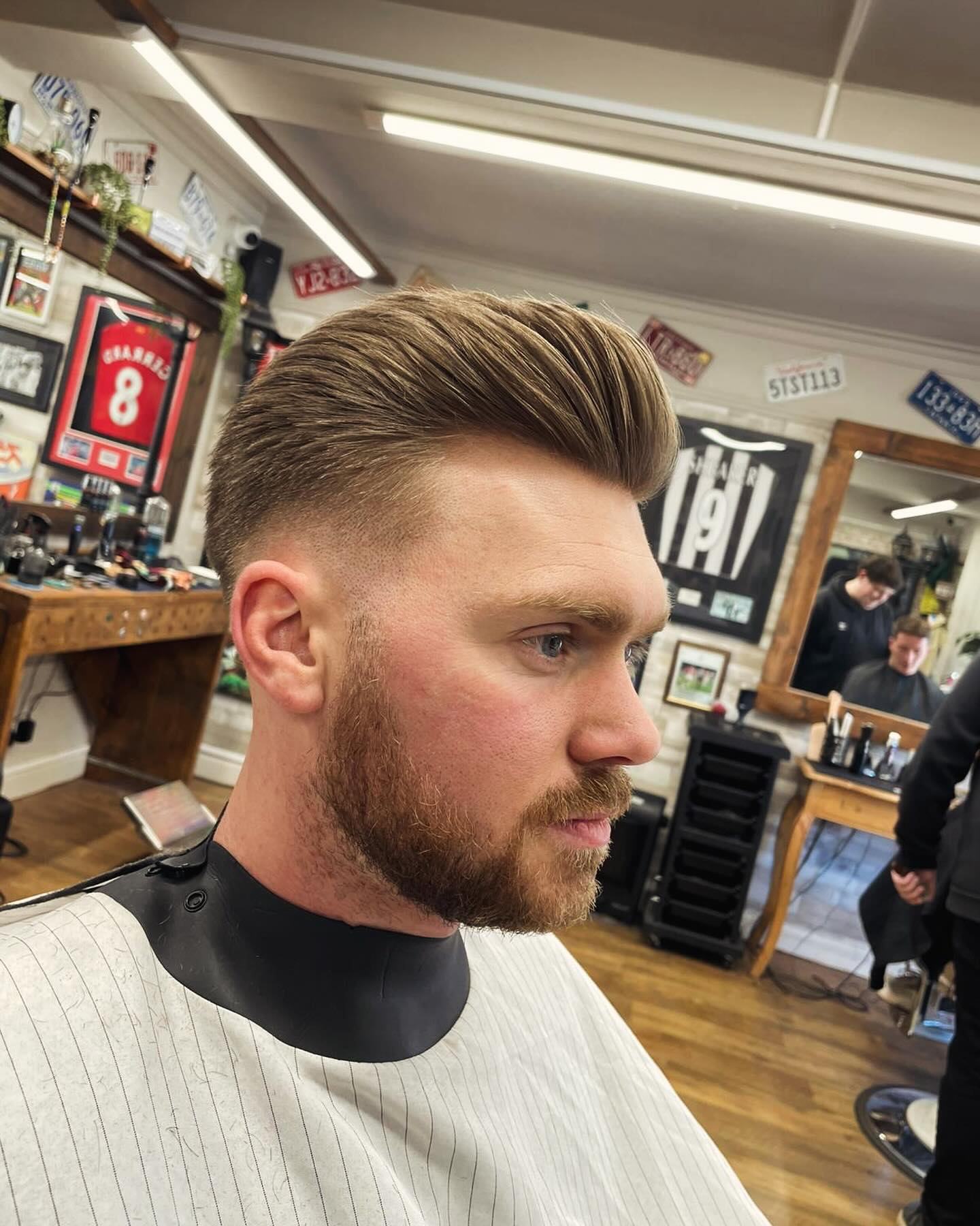 Textured quiff with a skin fade and a full shaped beard, in the barber room