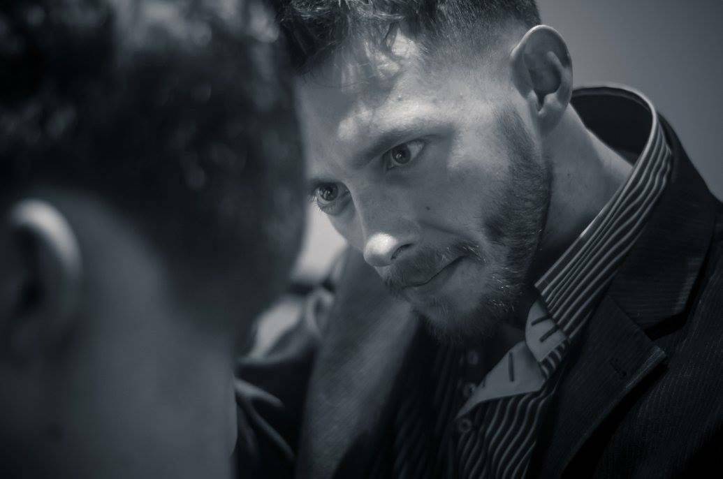 A barber concentrating on a cut
